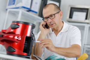 man looking at defective product